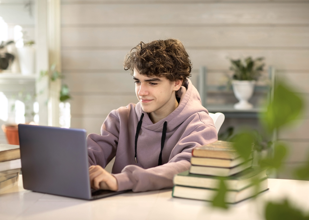 young man looking up most common questions about the ISEE